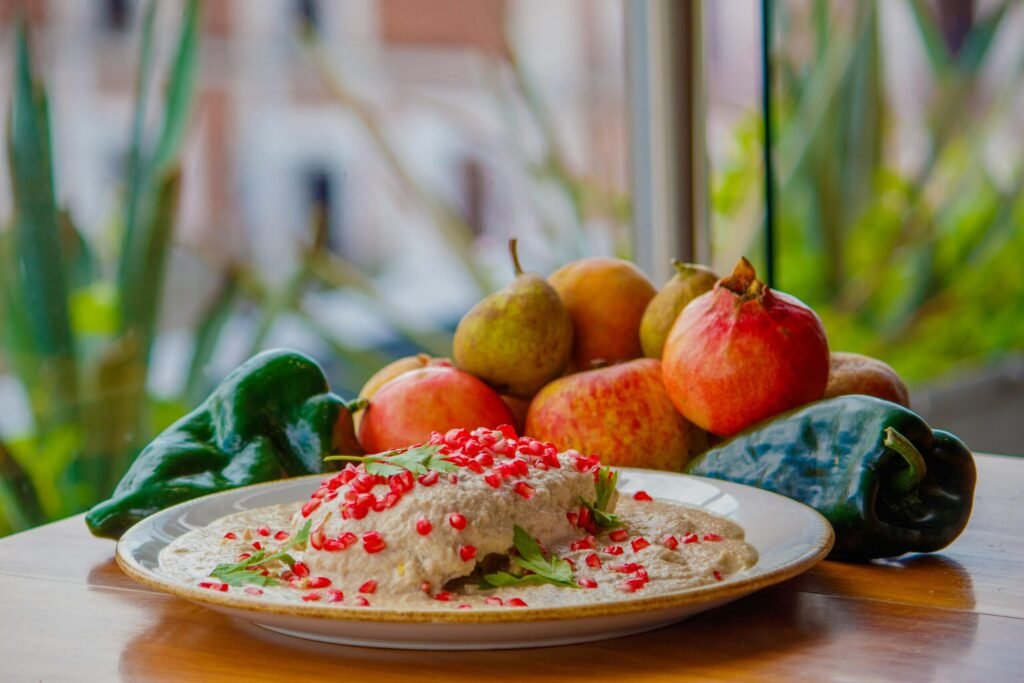 Delicious traditional Chile en Nogada from Puebla with fresh pomegranates and peppers.